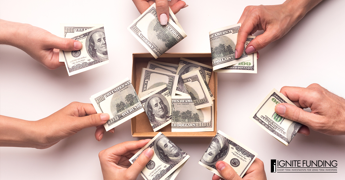 Hands putting money into a collective representing syndication