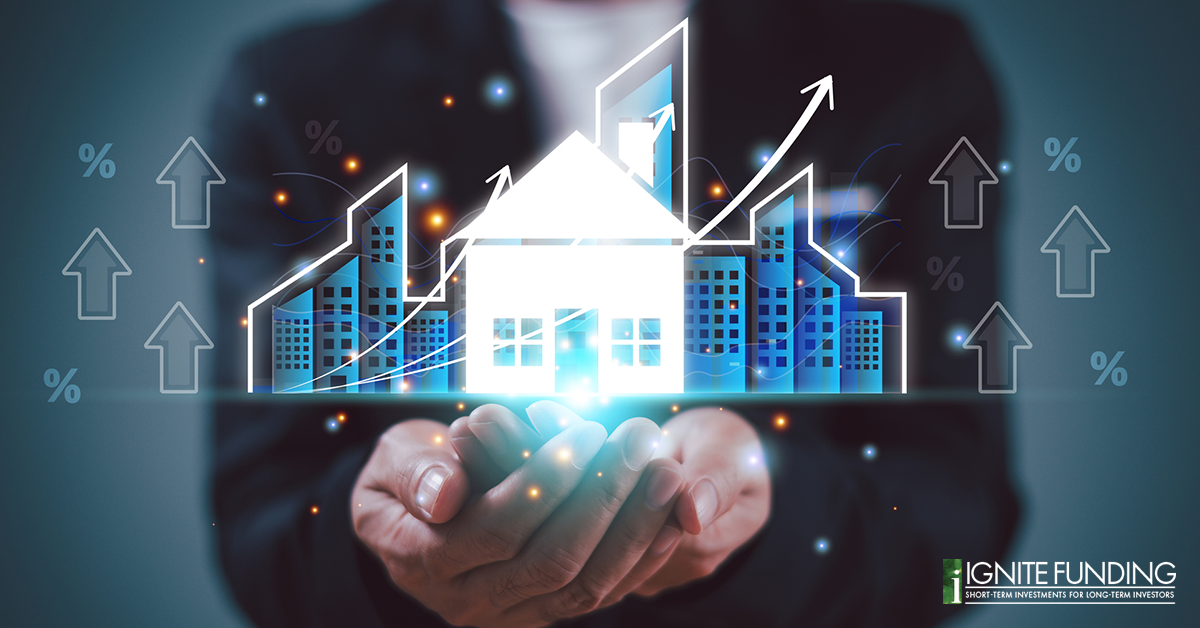 man working on laptop computer with icons representing real estate investment loans